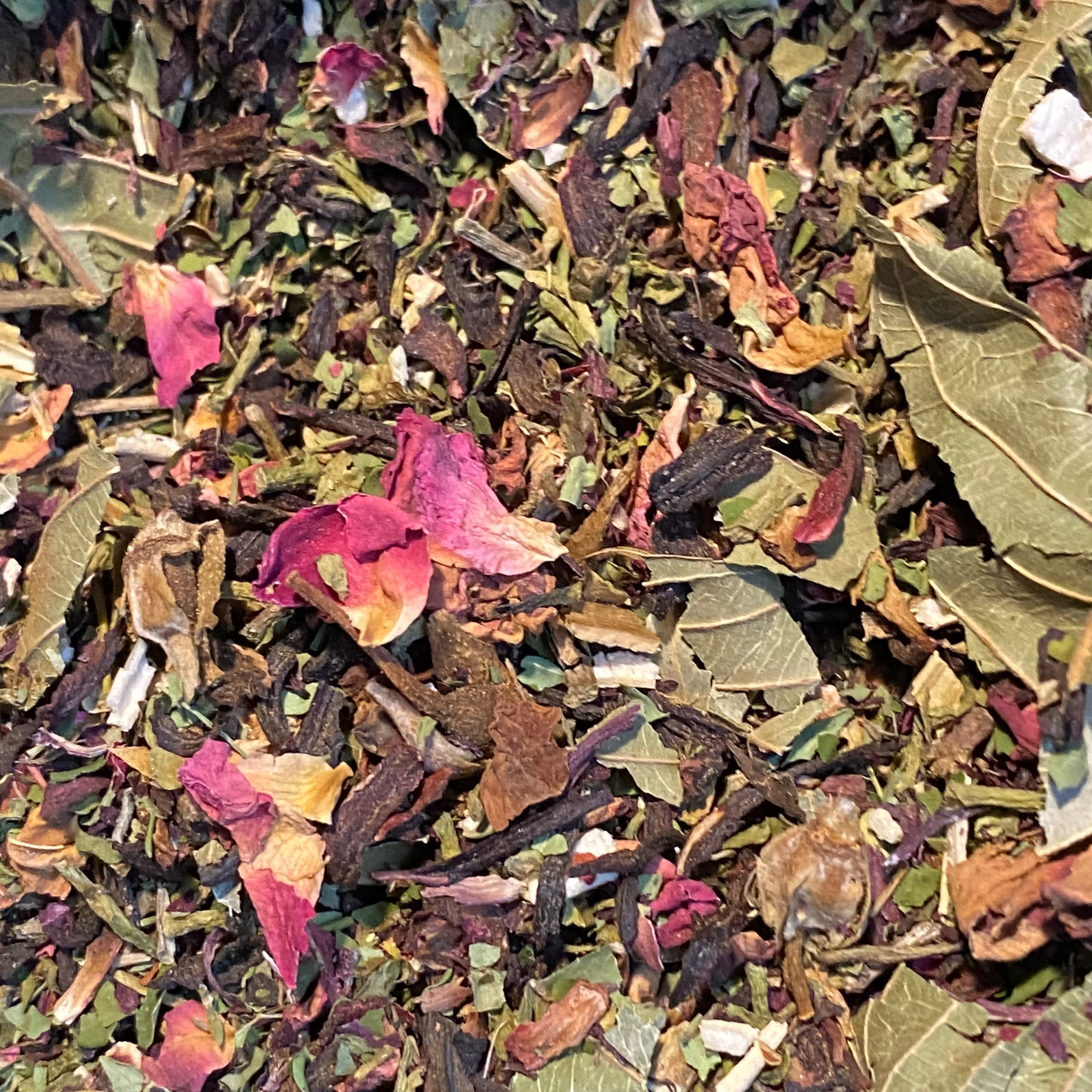 Assorted dried medicinal herbs and leaves with a mix of colors including green, red, and brown. Hibiscus and rose herbal tea for blood pressure support from Ayoni Wellness