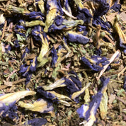 Close-up of dried butterfly pea flowers and green leaves Bacopa Monnieri for brain health by Ayoni Wellness